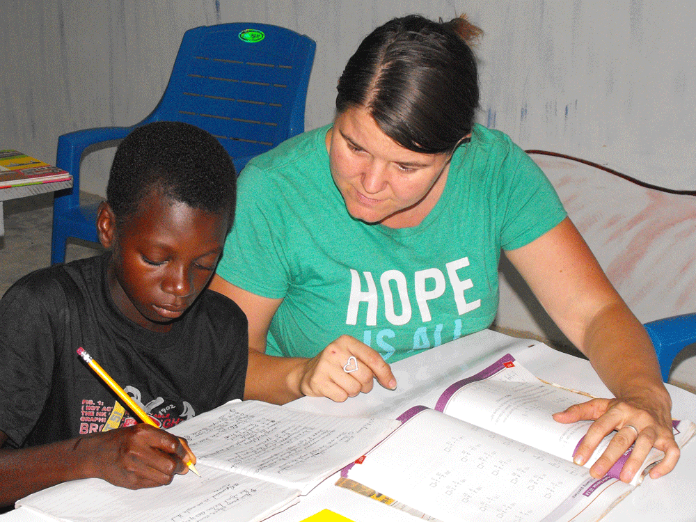Woman helping boy with schoolwork